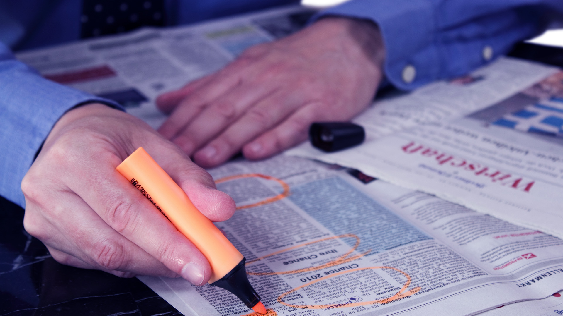 A man searching for a job holding a marker symbolizing Employment figures August 2022