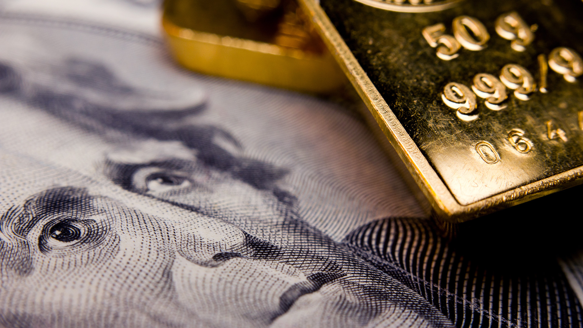 Gold bar and US dollar bill amid Gold is Currently Facing Selling Pressure While the Dollar is Stabilizing